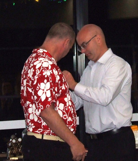 Life Member Michael Cumbo pins on the medallion for new Life Member Shaun Rayment. Life Member Michael Cumbo pins on the medallion for new Life Member Shaun Rayment.