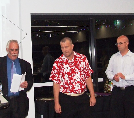 Life Member induction - Charlie Walker reads the citation for Shaun Rayment, while Mick Cumbo (right) waits to pin on his medallion. Life Member induction - Charlie Walker reads the citation for Shaun Rayment, while Mick Cumbo (right) waits to pin on his medallion.