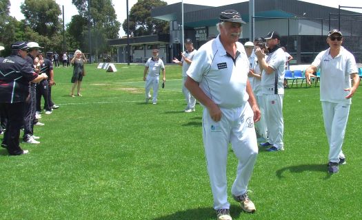 Charlie Walker walks through the guard of honor of his clubmates from the Fifths and the Seconds.