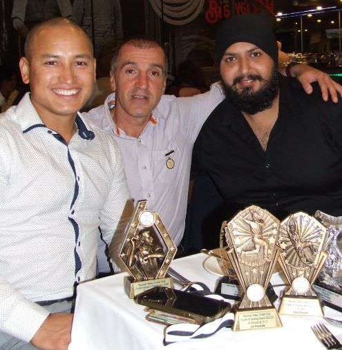 A table of trophies: L-R Sean O'Kane Award winner Chand Shrestha with Jim Polonidis and Manu Singh. A table of trophies: L-R Sean O'Kane Award winner Chand Shrestha with Jim Polonidis and Manu Singh.