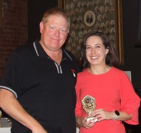 Women's team coach Darren Nagle presents the team's fielding award to Sarah Fenn - seven catches as keeper.